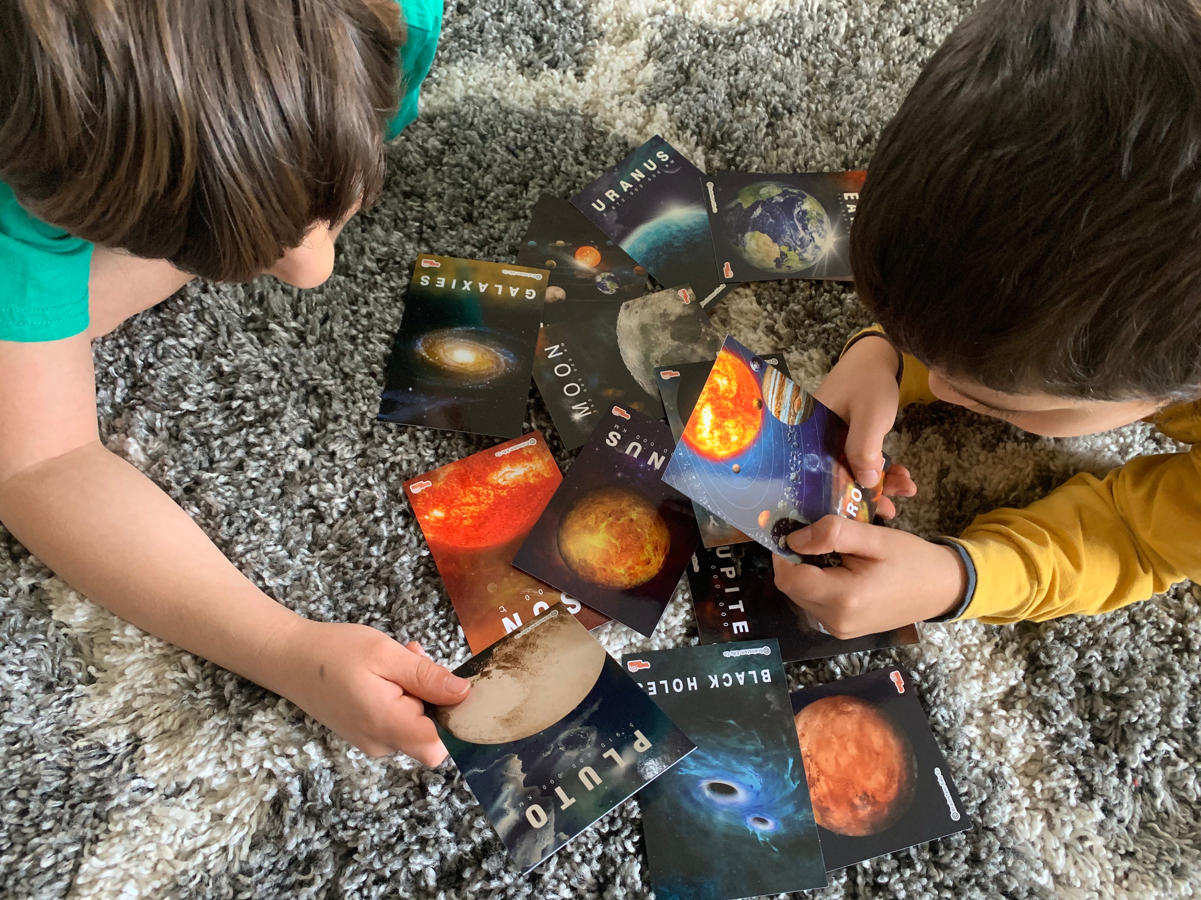 Child using tablet with augmented reality app to explore planets, playing and learning through interactive experience. Ideal for STEM education.